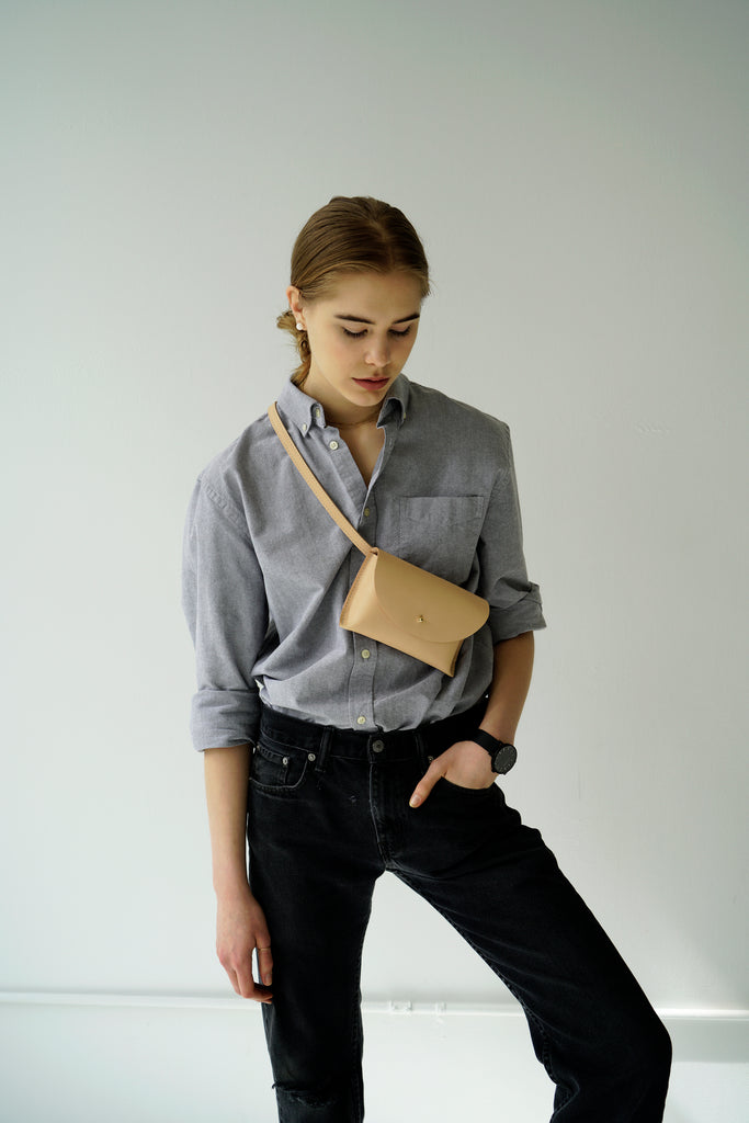 Female model with leather fanny pack