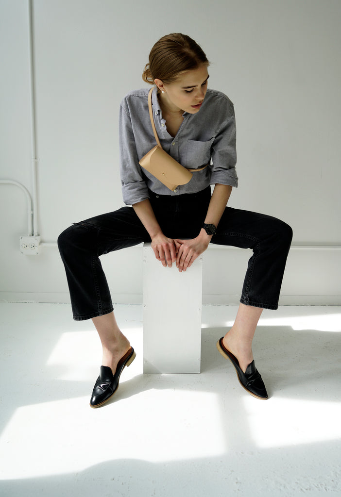 Female model with leather bag