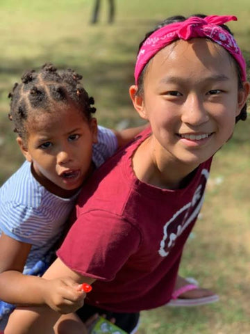 Volunteer Giving Child of the Dominican Republic A Piggy Back Ride