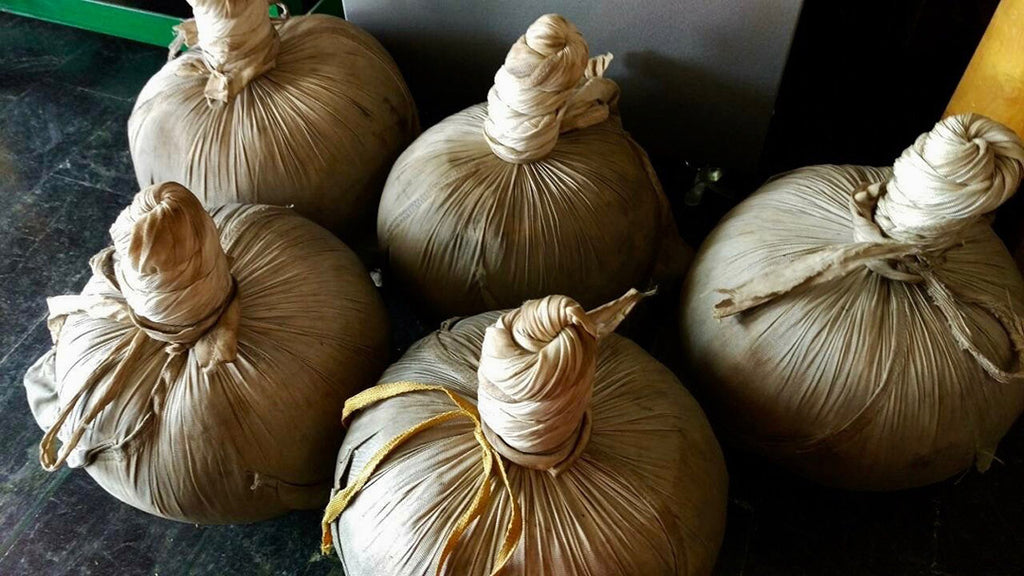 Tea leaves tightly wrapped into cloth balls in the rolling and drying process