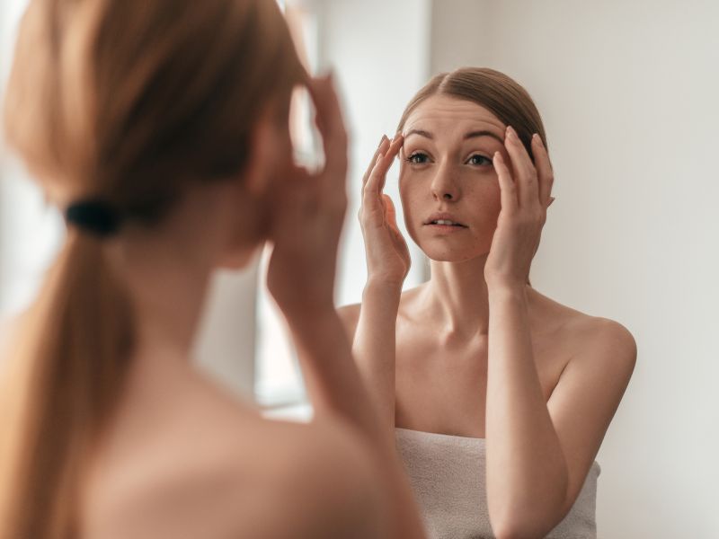 Women looking at self in mirror