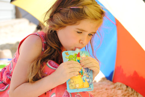girl eating from a yogurt pouch