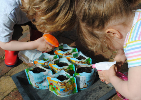 Nom Nom Kids Reusable Food pouches watering plants