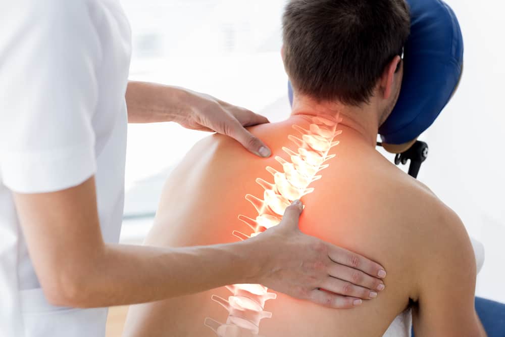 man getting physiotherapy on spine