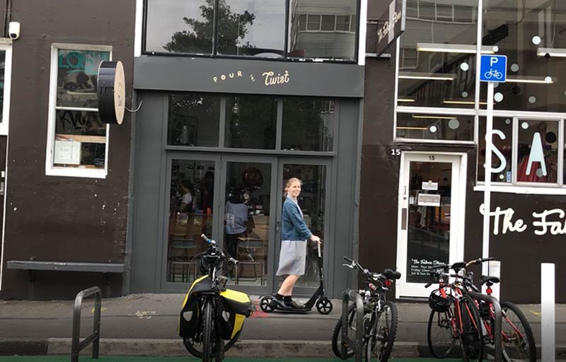 Hazel on her Downtown Micro Scooter in the City 