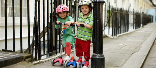 Two preschoolers having fun on their Micro scooters