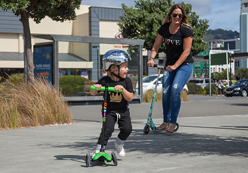 Mum scooting with her son using an adults scooter