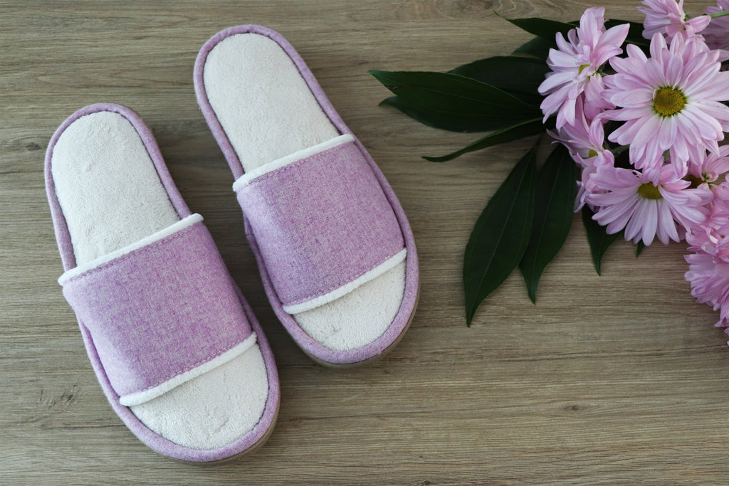 Summer Woolen Randi Slide Slippers flatlay sitting on wood with purple flowers