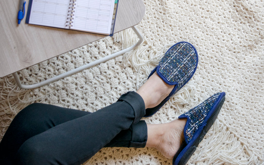 Kaitlyn Scuff on Model in Navy with her feet on a blanket working at a small table with an planner