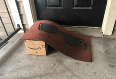 Amazon package under a welcome mat