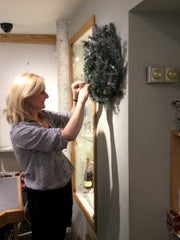 Marion putting up a wreath