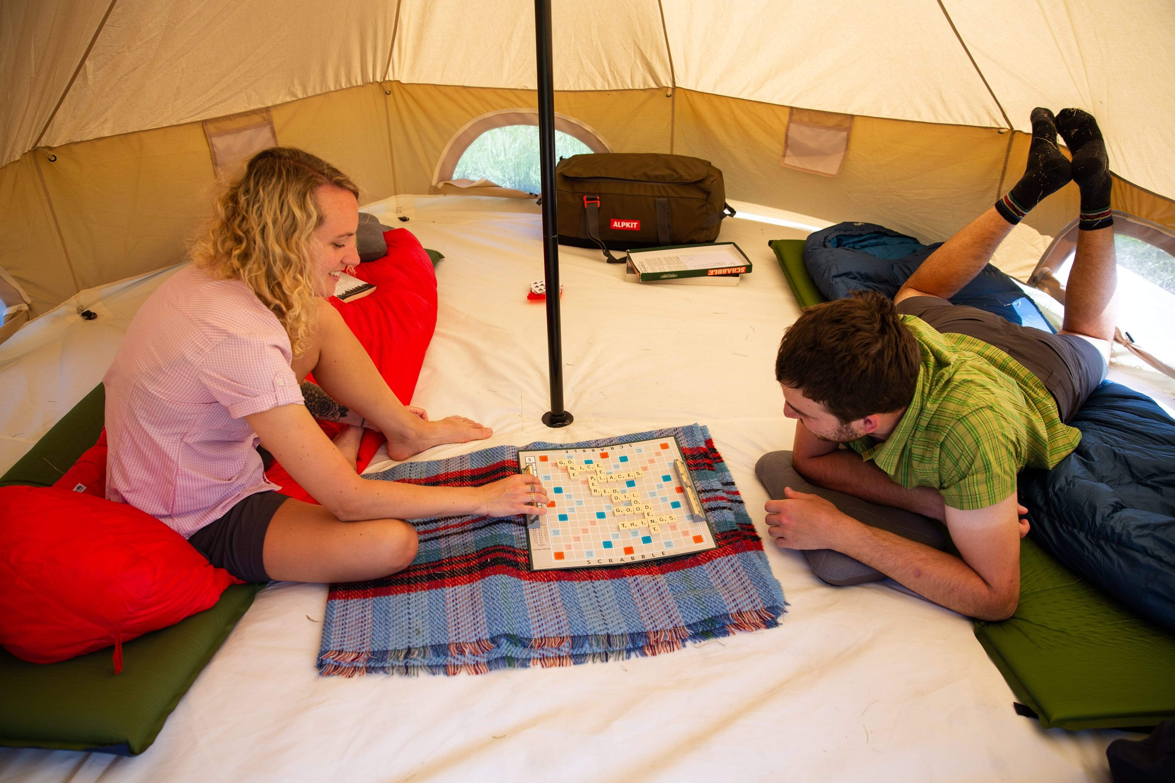 Playing Scrabble and board games inside the Roundhouse organic cotton bell tent