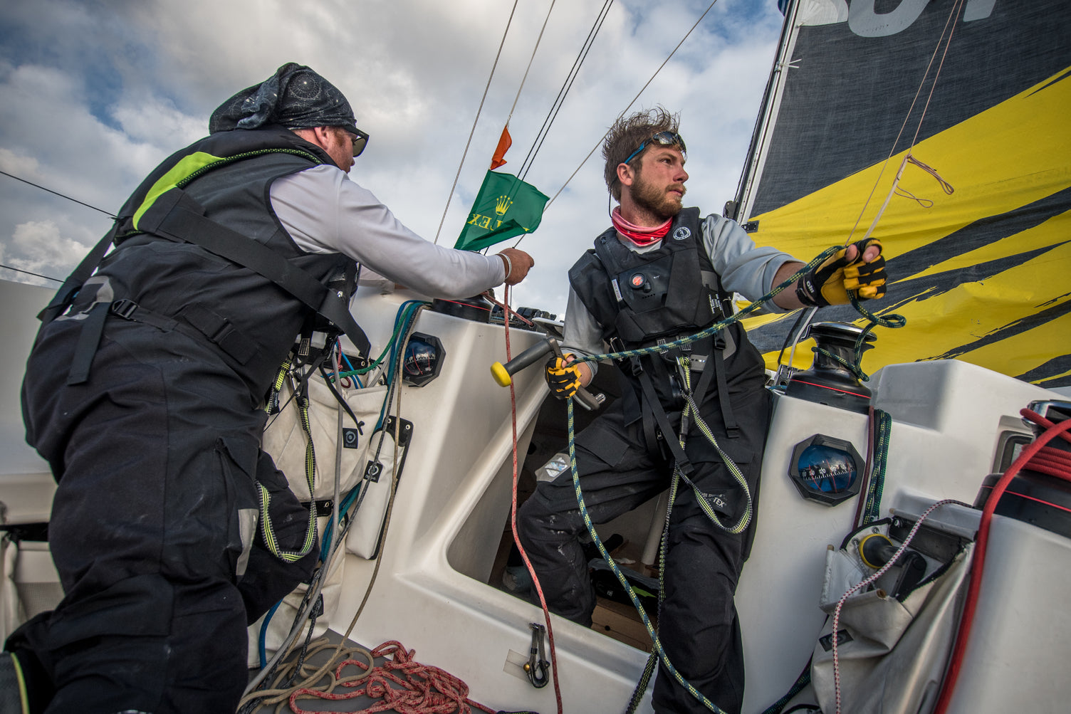 2 men adjusting sails and changing course