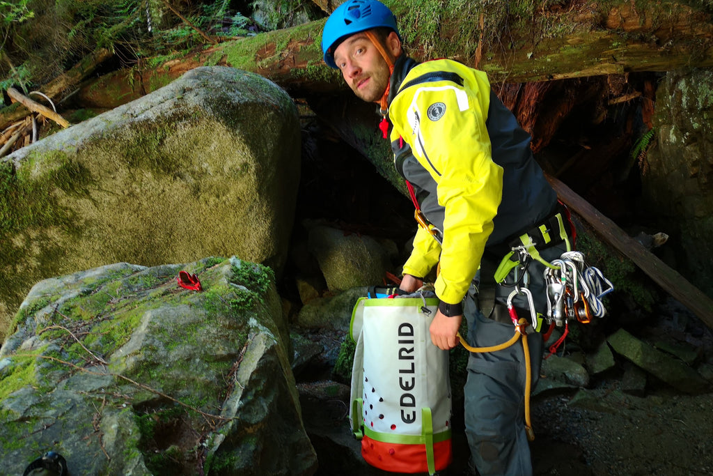 canyon guide sorting gear on wet rocks 