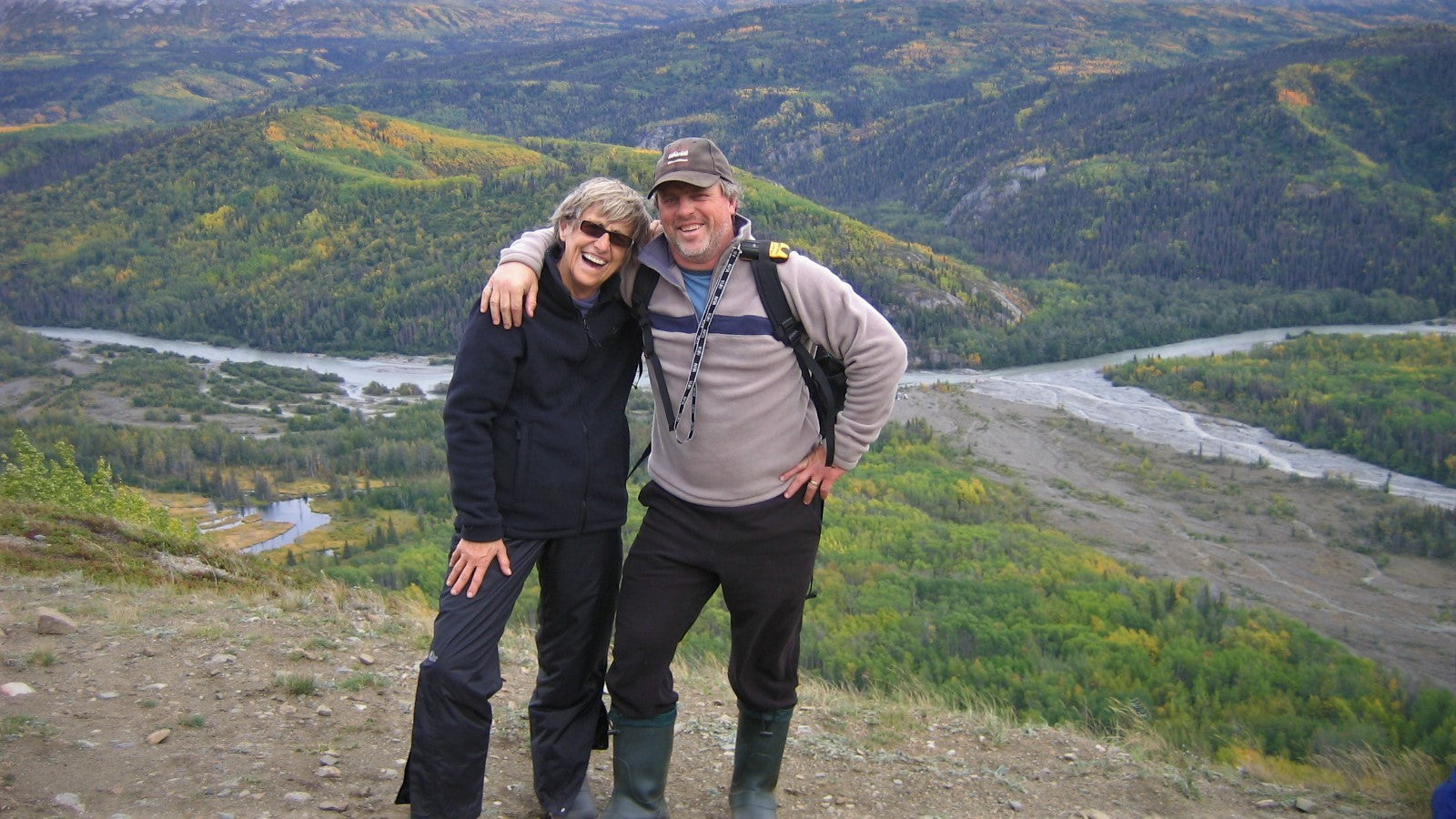 mother and son smiling atop a mountain