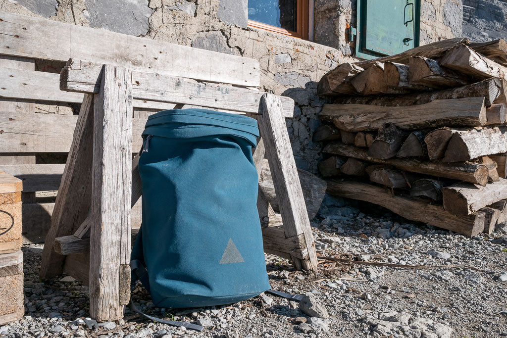 Blue backpack outside mountain hut
