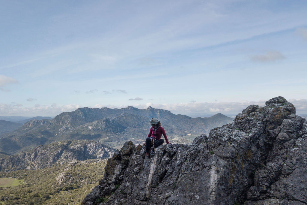 Rock climber at top of crag in Sierra de Grazalema, Spain