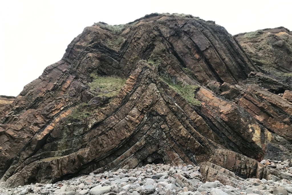 Folded sandstone rock strata on Northcott Mouth beach