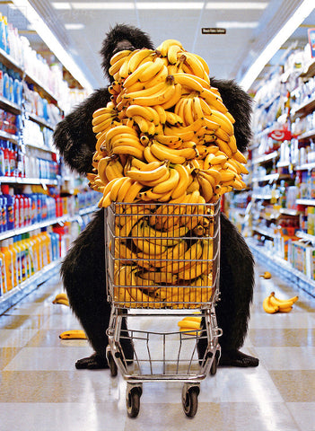 Gorilla pushing a shopping cart full of bananas