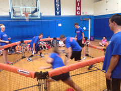 Camp counselors playing GaGa Ball game in school gym