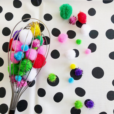 baby sensory play idea whisk with colourful pom poms