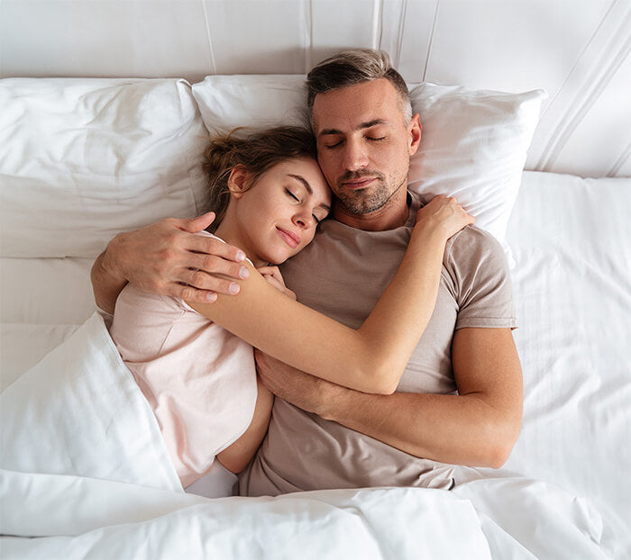 Couple sleeping cuddled together