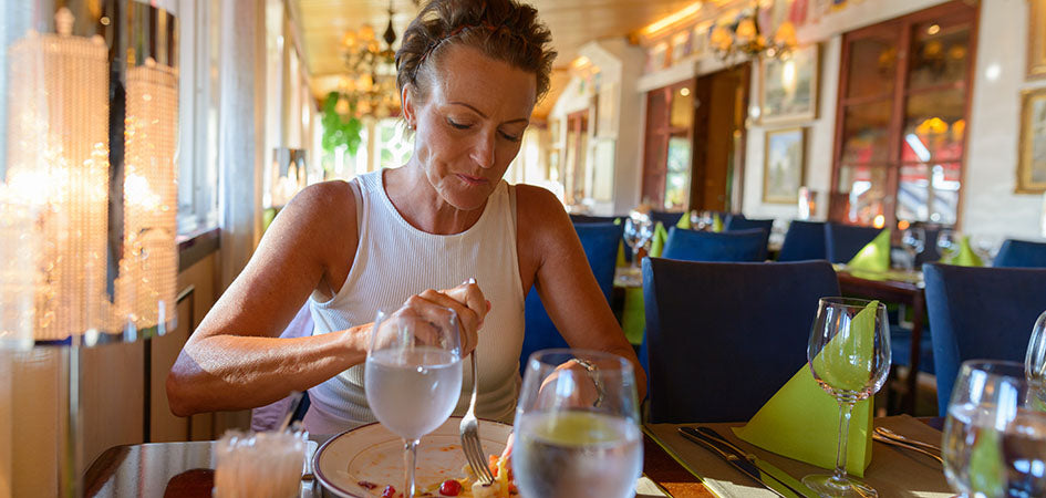 Woman eating at a restaurant. cbd balm for back pain. Does cbd balm work for pain?