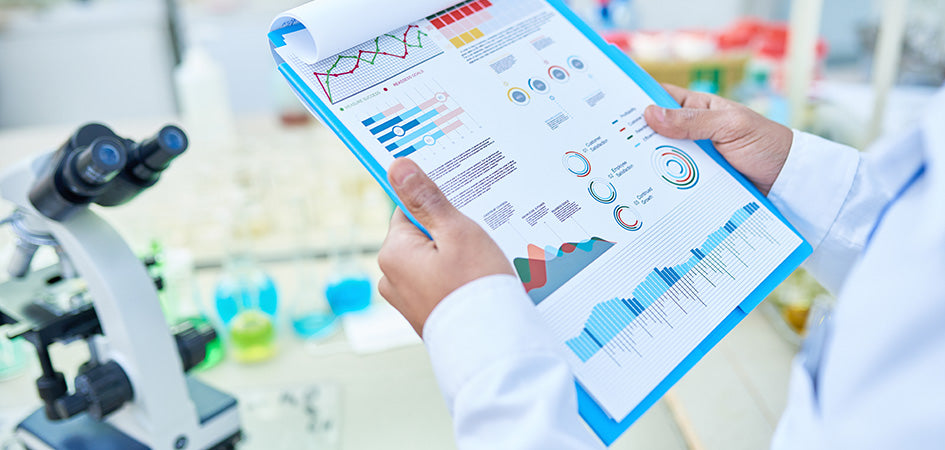 lab technician reviewing data on clipboard. Where to buy cbd oil online in the USA.