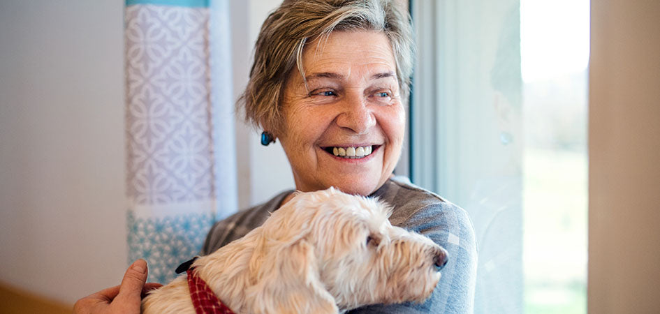 Mature happy woman with her dog. buy cbd oil online. Where to buy cbd oil in the USA?
