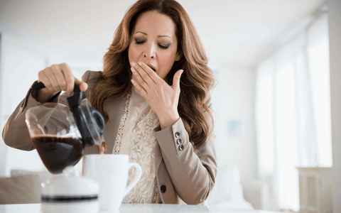 pouring morning coffee and yawning