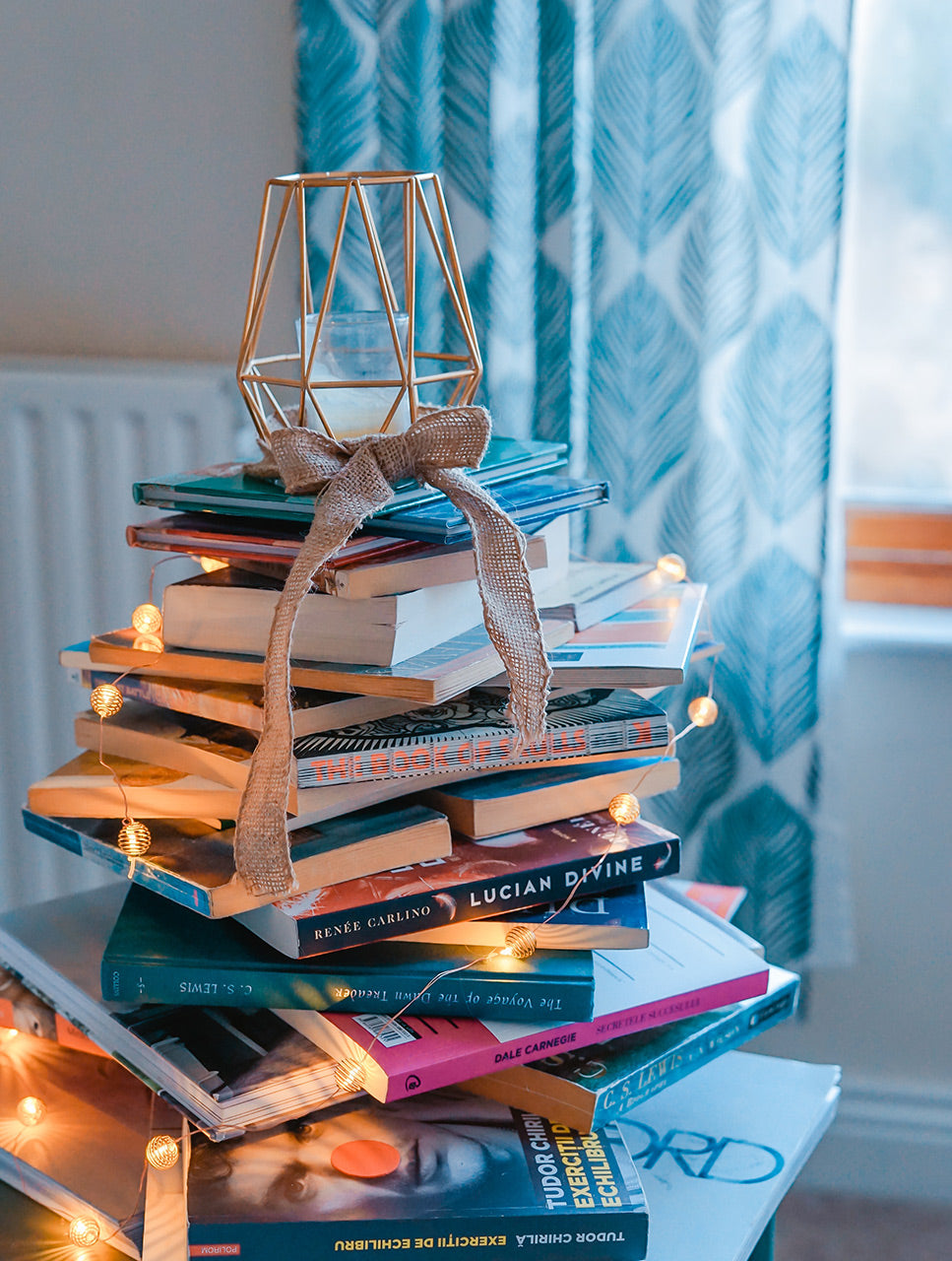 Pile of reading books in cosy room.