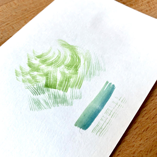 Close up of a dry brushing watercolour technique in green paint
