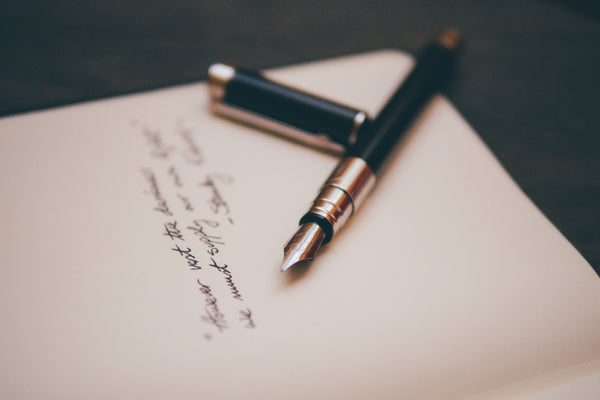 close up of blank paper with handwriting and a fountain pen 