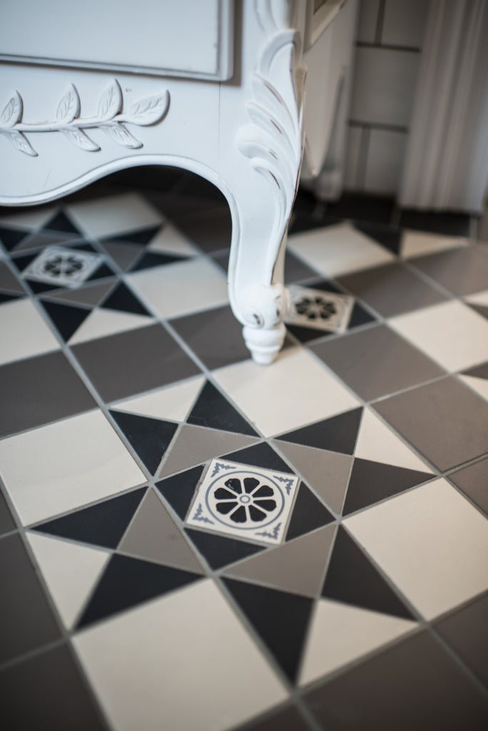 Monochrome tessellated tiles with French Provincial cabinet