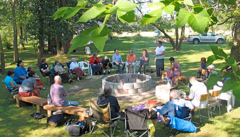 A group of people gathered around a fire pit