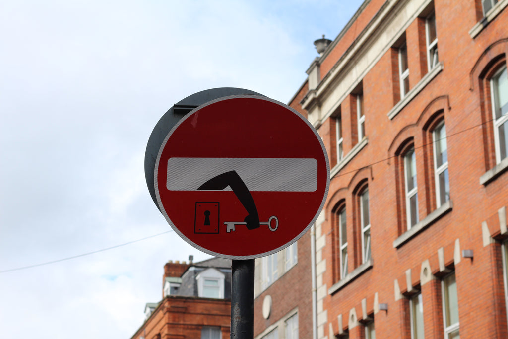 Street sign with street art in Dublin / Ireland