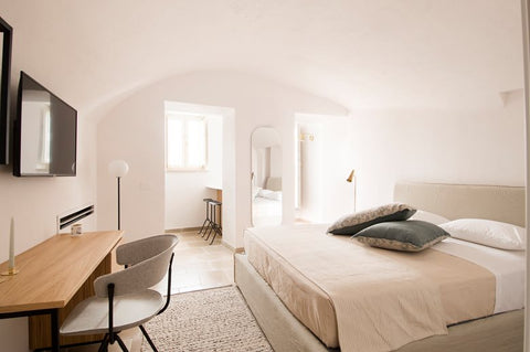 Bright white bedroom with grey chair