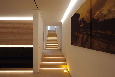 Staircase with warm lighting and large painting