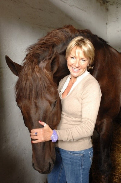 Tracy Piggott - Former Jockey and Broadcaster petting a horse