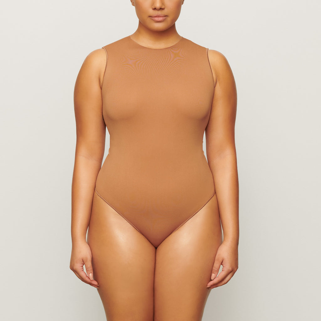 ESSENTIAL CREW NECK SLEEVELESS BODYSUIT - CAMEL | SKIMS