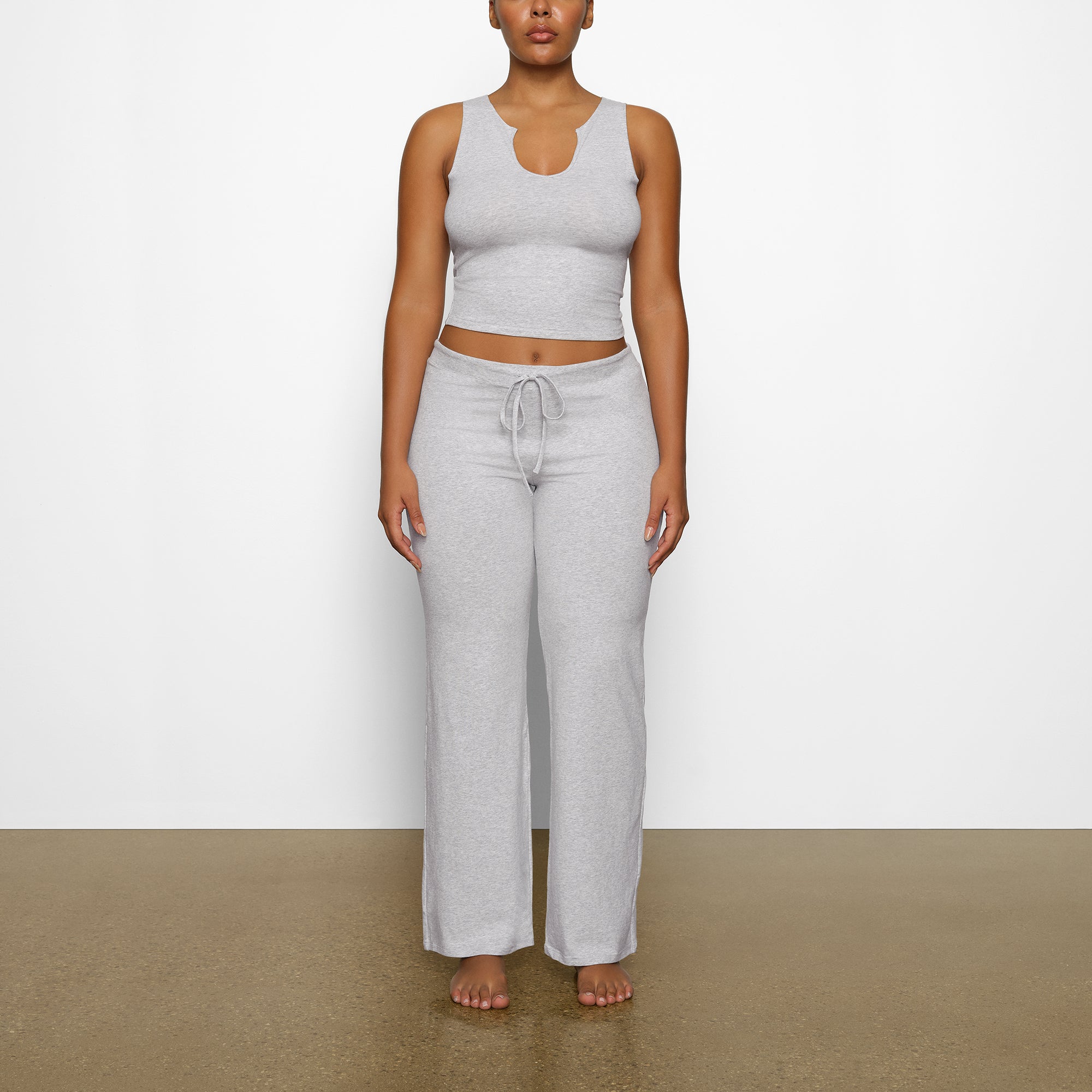 SKIMS wearing a size small in light heather grey folded pants and shi, skims  fold over pant