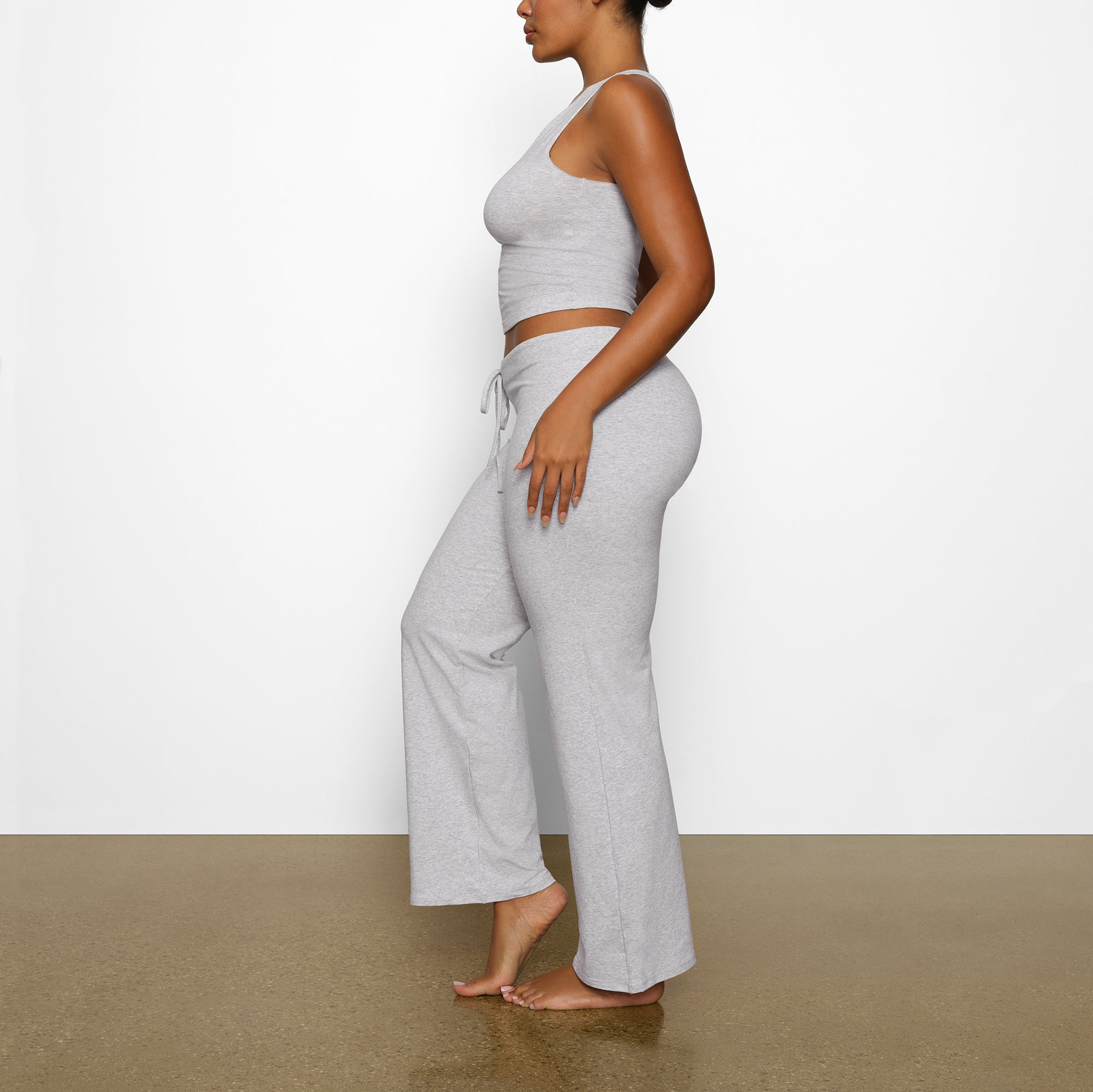 SKIMS wearing a size small in light heather grey folded pants and shi, skims fold over pant