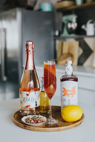 Amour cocktail ingredients, rose and honey water, Wild Life Botanicals Blush sparkling wine, and Sensor Love 