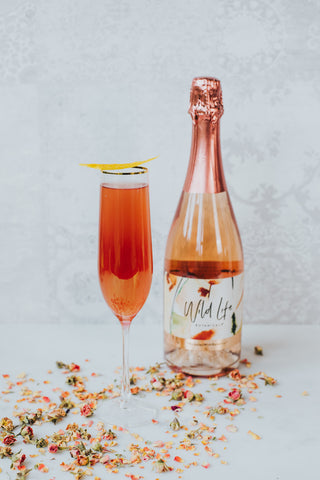 Amour non-alcoholic cocktail, with a bottle of Wild Life Botanicals Blush