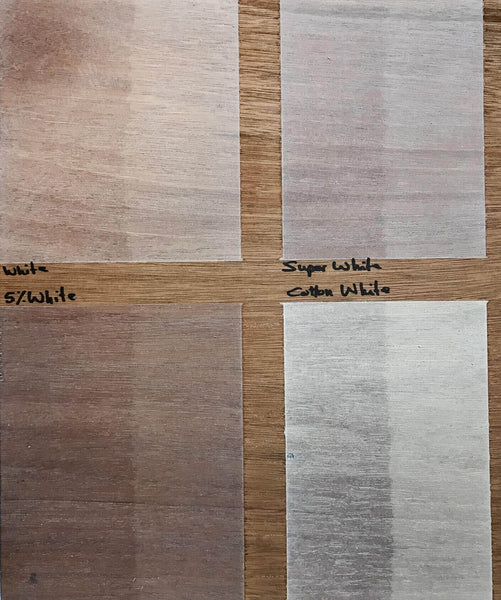 Four light wood finish color samples shown on mahogany wood.