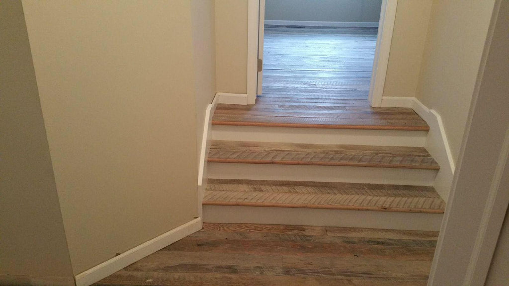 Light rustic wood steps down into a hallway