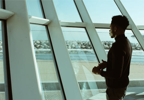 man looking out window