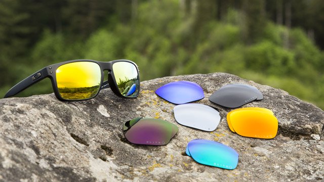 Pair of sunglasses with lenses laying on a rock