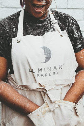 Luminary Trainee with hands in Apron
