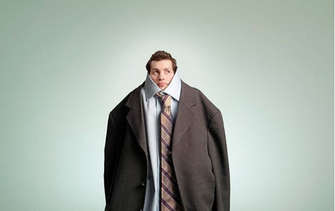 Man comically too small for his suit